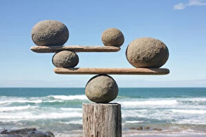Balance Collection: Rocks balancing on driftwood, sea in background