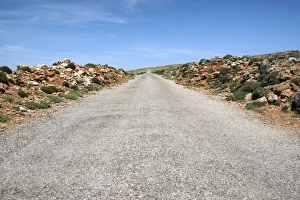 Rocks lining a straight country road at Cap de Cavalleria, Cap de Cavalleria, Menorca Rocks lining a straight country road at Cap de Cavalleria, Cap de Cavalleria, Menorca