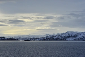 Rocky island landscape at the north sea with cloudy sky, Soroysund, Finnmark County Rocky island landscape at the north sea with cloudy sky, Soroysund, Finnmark County