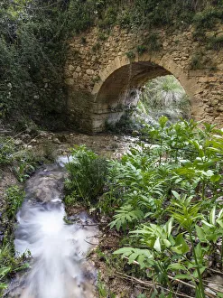 Roman bridge into a ravine in a mountain stream Roman bridge into a ravine in a mountain stream