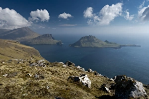 Rugged rocks of Tindholmur seen from the hiking trail between Bour and Gasadalur, Vagar Rugged rocks of Tindholmur seen from the hiking trail between Bour and Gasadalur, Vagar