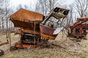 Rusty harvesters in an abandoned farm. Chernobyl zone, Ukraine Rusty harvesters in an abandoned farm. Chernobyl zone, Ukraine