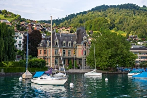 Sailing boats and village beside lake Thun Sailing boats and village beside lake Thun