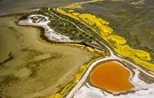 Salt patterns on the surface of salt marshes, brackish water area with colourful old salines, near Aigues-Mortes Salt patterns on the surface of salt marshes, brackish water area with colourful old salines, near Aigues-Mortes