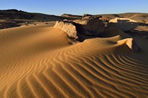 Sand dunes and sandblasted rocks on Tadrart plateau, Tassili nAjjer National Park, Unesco World Heritage Site, Sahara Sand dunes and sandblasted rocks on Tadrart plateau, Tassili nAjjer National Park, Unesco World Heritage Site, Sahara