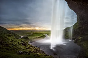 <b class=qtipBold><figcaption>Seljalandsfoss Sunset</figcaption></b><br>Seljalandsfoss is one of the best known waterfalls in Iceland. This waterfall of the river SeljalandsA¡ drops 60 metres (200 ft) over the cliffs of the former coastline. It is possible to walk behind the waterfall.<br><em>© Copyright 2015 Xiaoyu Yu</em> Seljalandsfoss Sunset