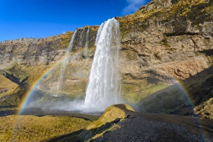 Seljalandsfoss waterfall and rainbow, Iceland Seljalandsfoss waterfall and rainbow, Iceland
