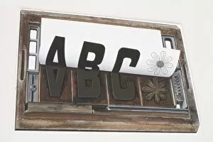 Printing Gallery: Sheet of paper peeling away from a printing forme imprinted with the letters ABC