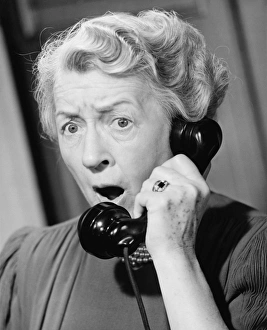 Shocked woman using phone, (B&W), close-up Shocked woman using phone, (B&W), close-up