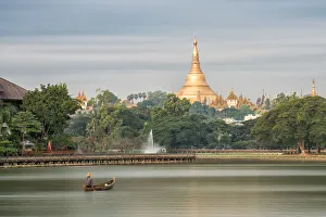 Shwedagon Pagoda in the morning view at wooden boardwalk at the Kandawgyi Lake in Yangon Shwedagon Pagoda in the morning view at wooden boardwalk at the Kandawgyi Lake in Yangon
