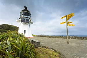 Signpost with distances and lighthouse at Cape Reinga, Cape Reinga, Northland Region Signpost with distances and lighthouse at Cape Reinga, Cape Reinga, Northland Region