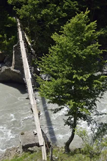 Simple suspension bridge over the Enguri river, Svaneti or Svanetia, Caucasus Mountains Simple suspension bridge over the Enguri river, Svaneti or Svanetia, Caucasus Mountains