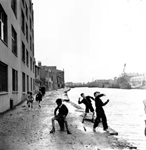 Skimming Stones; A group of children playing in the racially diverse dockland area of Skimming Stones; A group of children playing in the racially diverse dockland area of