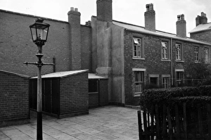 <b class=qtipBold><figcaption>Slum Wash House</figcaption></b><br>29th October 1955: Two newly built wash houses replace two slum houses at a Birmingham street. Original Publication: Picture Post - 8127 - The Housing Jungle - pub. 1955 (Photo by Raymond Kleboe/Picture Post/Getty Images) Slum Wash House