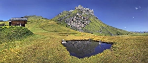 Small lake or pond at Mt Peitlerkofel, Sasso delle Putia, with mountain hut, Villnoess Small lake or pond at Mt Peitlerkofel, Sasso delle Putia, with mountain hut, Villnoess