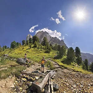 Small spring at Mt Peitlerkofel, Sasso delle Putia, with hiker at Wuerzjoch, Passo delle Erbe, Villnoess, Funes Small spring at Mt Peitlerkofel, Sasso delle Putia, with hiker at Wuerzjoch, Passo delle Erbe, Villnoess, Funes
