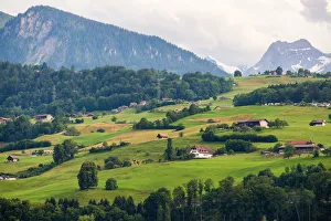 Small village over the meadow near lake Thun Small village over the meadow near lake Thun