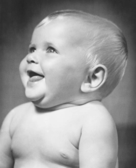 Smiling baby (6-12 months), (B&W), close-up Smiling baby (6-12 months), (B&W), close-up
