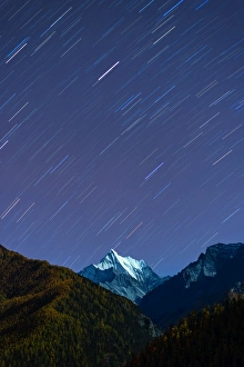 Snowy mountain peak and Star trail in Yading Snowy mountain peak and Star trail in Yading