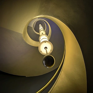 <b class=qtipBold><figcaption>Spiral Staircase</figcaption></b><br>Oslo, Norway 2014. A classic spiral staircase, with a long hanging electric lamp. Inside an old building. Warm colors. Upwards perspective.<br><em>© ©2014 Runar Vestli</em> Spiral Staircase