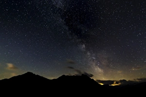 Starry sky with the Milky Way over a mountain landscape, with light pollution, Safien, Canton of Graubunden Starry sky with the Milky Way over a mountain landscape, with light pollution, Safien, Canton of Graubunden