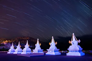 Startrail over Tibertan stupas at Feilai Si temple Startrail over Tibertan stupas at Feilai Si temple