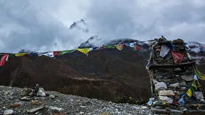 Stone marker with Buddhist prayer flags, Everest base camp trek, Sagarmatha National Park Stone marker with Buddhist prayer flags, Everest base camp trek, Sagarmatha National Park