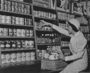 <b class=qtipBold><figcaption>At The Store</figcaption></b><br>A woman taking canned goods from the shelves of a grocery store circa 1930. (Photo by Keystone View/FPG/Getty Images)<br><em>© 2011 Getty Images</em> At The Store