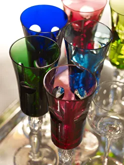 Stylish, colourful tinted champagne glasses on a silver platter Stylish, colourful tinted champagne glasses on a silver platter