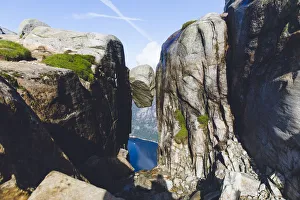 <b class=qtipBold><figcaption>Summer adventure in Norway</figcaption></b><br>Kjeragbolten, Norway - August 14, 2017: Front view of the famous rock named Kjeragbolten, which looks like a bean stuck between two bigger rocks. A lot of people take the 3-hours trail to have a chance for a picture standing on the 'bean'. This photo was luckily taken early morning, when there have been no lines and Kjerag could be captured completely empty.<br><em>© Veronica Verlan 2017</em> Summer adventure in Norway