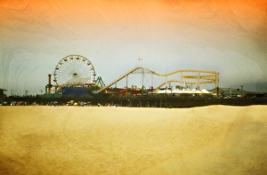 <b class=qtipBold><figcaption>Summertime Amusement</figcaption></b><br>Painterly, textured image of Santa Monica pier and Pacific Park Amusement Park rides with unrecognizable sunbathers and beach umbrellas in distant foreground.<br><em>© 2010-2011 SusanGaryPhotography</em> Summertime Amusement