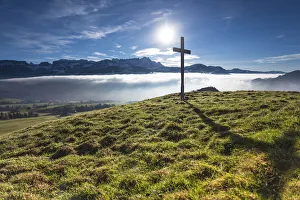 Summit cross of Gerenberg Mountain with high fog in front of the Alpstein Mountains, Gerenberg, Appenzell, Switzerland Summit cross of Gerenberg Mountain with high fog in front of the Alpstein Mountains, Gerenberg, Appenzell, Switzerland