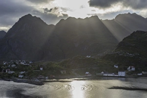 Sun rays breaking through the clouds over the mountains of the municipality of Moskenes Sun rays breaking through the clouds over the mountains of the municipality of Moskenes