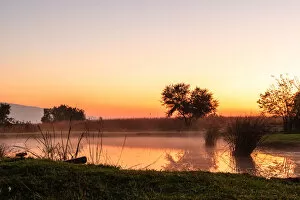 Images Dated 23rd May 2008: The sun rises over a small dam in the high veld winter landscape near Hartebeespoort, South Africa