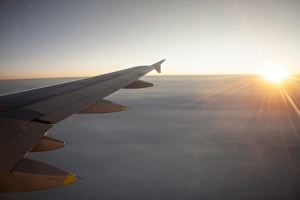 Sunrise from an airplane above the clouds with wing unit, above Norway Sunrise from an airplane above the clouds with wing unit, above Norway