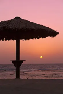 Sunrise with beach parasol, Dahab, Egypt, Africa Sunrise with beach parasol, Dahab, Egypt, Africa