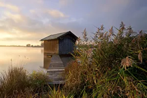 Sunrise with a fishermans hut and a light morning mist near Rimsting on Lake Chiemsee Sunrise with a fishermans hut and a light morning mist near Rimsting on Lake Chiemsee