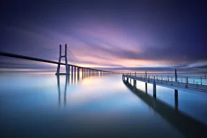 <b class=qtipBold><figcaption>Sunrise in Vasco da Gama bridge</figcaption></b><br>The Vasco da Gama bridge Lisbon is a massive 17km long bridge that spans the shallow but wide Tagus Estuary to the east of Lisbon. This massive bridge was once Europe longest bridge and was named after Portugal great explorer Vasco da Gama.<br><em>© FredConcha</em> Sunrise in Vasco da Gama bridge