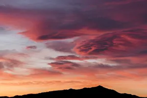 Sunset lights up clouds above mountain ridge in Joshua Tree National Park's southern region Sunset lights up clouds above mountain ridge in Joshua Tree National Park's southern region