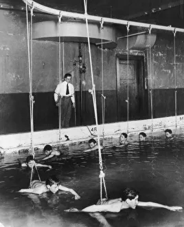 <b class=qtipBold><figcaption>Swimming Lesson</figcaption></b><br>Circa 1930, Boys learn to swim on a kind of underwater merry-go-round at a school in Cincinnati. (Photo by FPG/Getty Images) Swimming Lesson