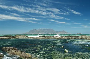 Table Mountain across the bay with rock pool in foreground Table Mountain across the bay with rock pool in foreground