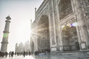 <b class=qtipBold><figcaption>The Taj Mahal</figcaption></b><br>Sun peeks around the Taj Mahal as tourists wander the complex in Agra, India.<br><em>© powerofforever</em> The Taj Mahal
