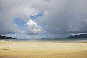 Tannic river flowing into a churning sea under storm clouds, beach at Porta Salon Tannic river flowing into a churning sea under storm clouds, beach at Porta Salon