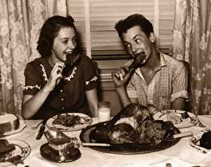 Images Dated 30th August 2005: Teenage girl and boy (15-17) eating turkey dinner (B&W sepia tone)