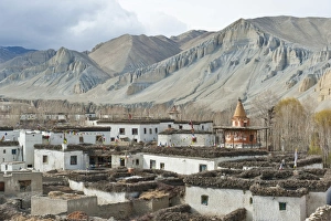 Tibetan architecture, houses with flat roofs, erosion in the mountains, typical stupa in the village Charang Tibetan architecture, houses with flat roofs, erosion in the mountains, typical stupa in the village Charang