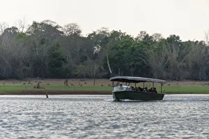 Tourists in safari boat on Kabini Reservoir, Nagarhole National Park, Karnataka, India Tourists in safari boat on Kabini Reservoir, Nagarhole National Park, Karnataka, India