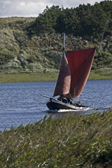 Traditional fishing boat with foresail and spritsail in the RinkAAžbing fjord at Traditional fishing boat with foresail and spritsail in the RinkAAžbing fjord at