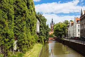 Traditional historic houses covered with ivy on a canal in the old town of Gdansk, Poland Traditional historic houses covered with ivy on a canal in the old town of Gdansk, Poland