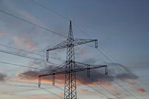 Transmission tower or electricity pylon, evening mood, cloudy sky, Baden-Wuerttemberg Transmission tower or electricity pylon, evening mood, cloudy sky, Baden-Wuerttemberg