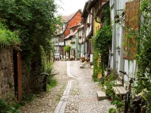 Prints of Old narrow alley with half-timbered buildings in Quedlinburg a town located in the district of Harz in Saxony Anhalt, Germany Travel Imagery Prints: Quedlinburg Old Town Alleyways Print